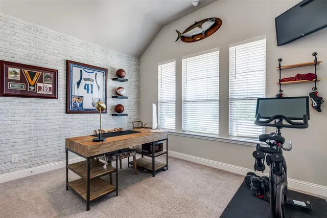 a view of a workspace with furniture and a window