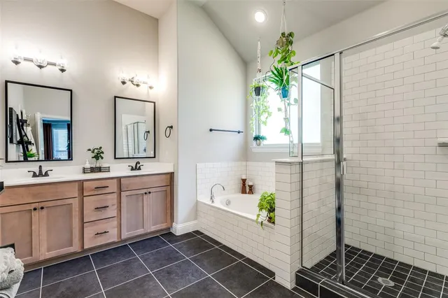 a bathroom with a bathtub sink and mirror