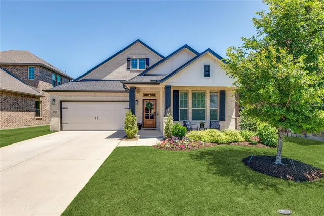 a front view of a house with a yard and porch