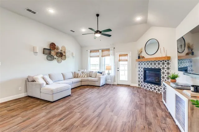 a living room with furniture a fireplace and a flat screen tv