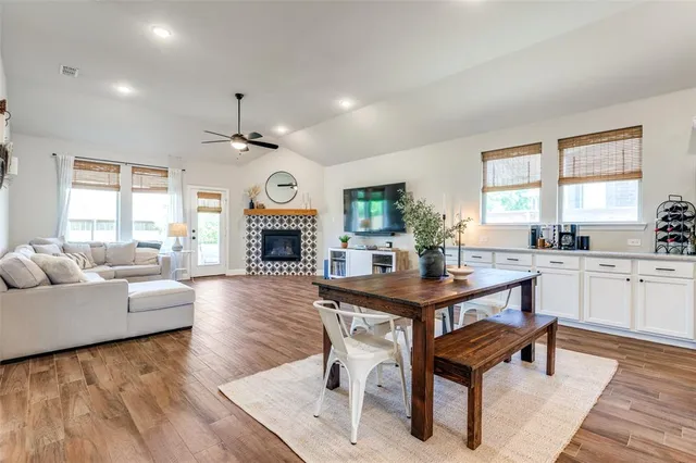 a living room with fireplace furniture and a large window