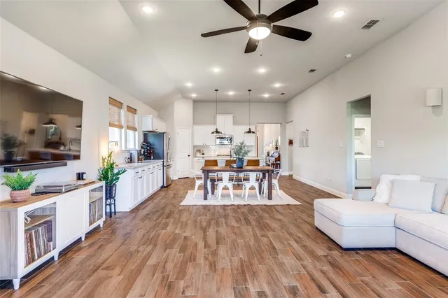 a living room with furniture and a wooden floor