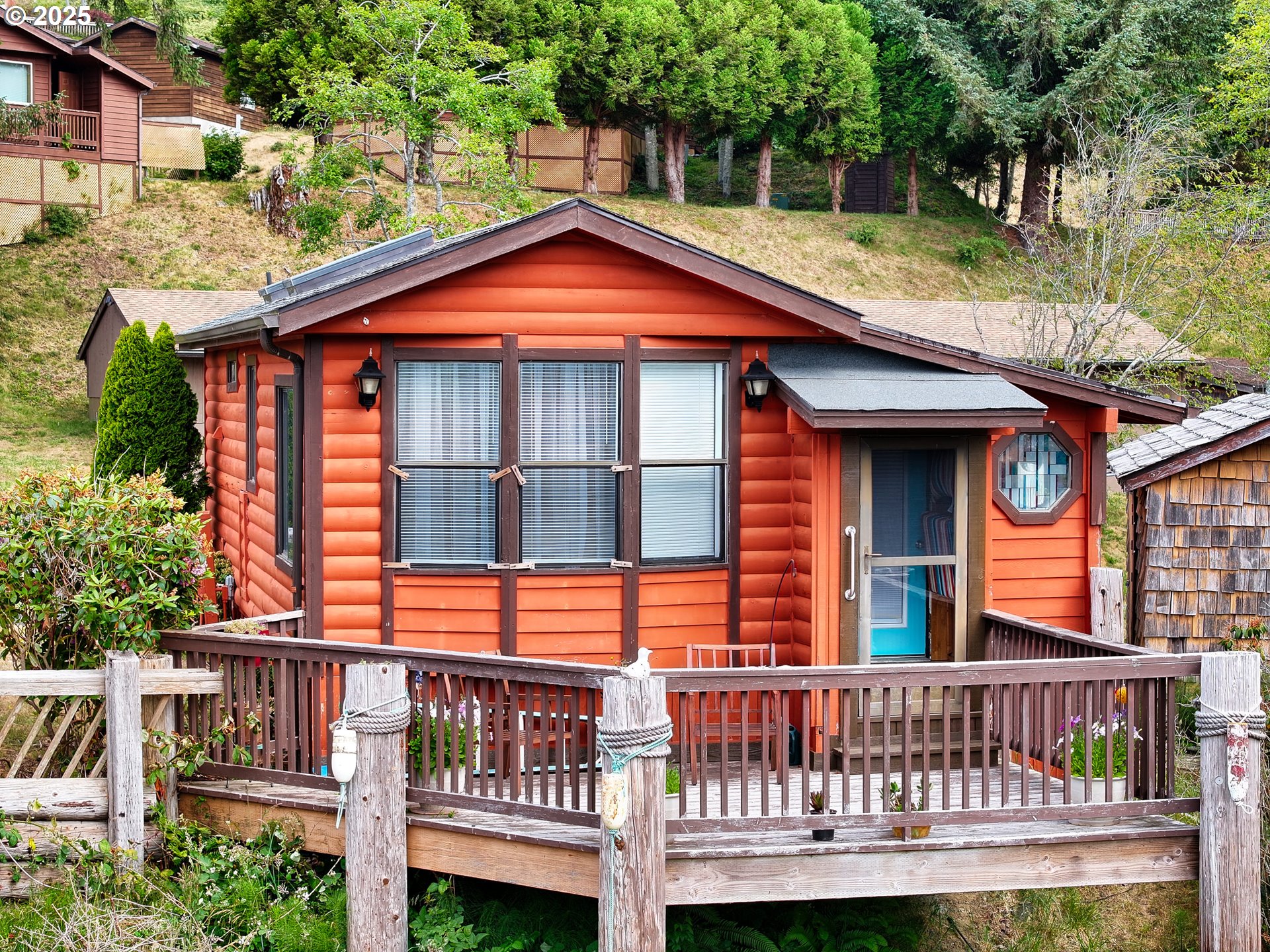 19921 Whaleshead Road, Unit M2 Brookings, OR 97415 - Photo 24 of 29 a view of a house with a yard and deck