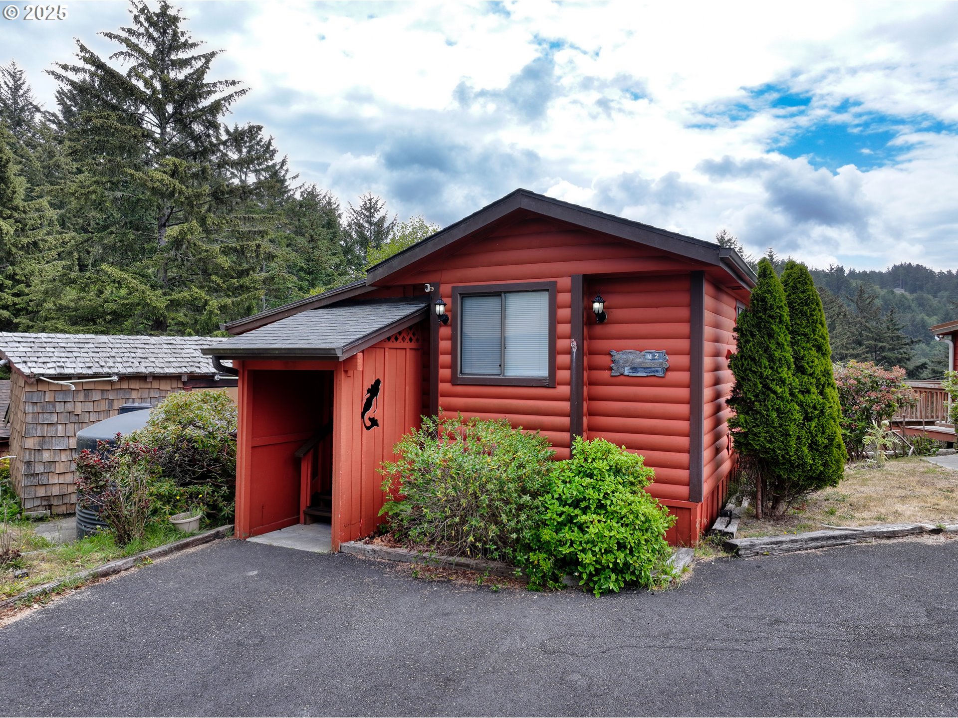 19921 Whaleshead Road, Unit M2 Brookings, OR 97415 - Photo 3 of 29 a front view of a house with a yard