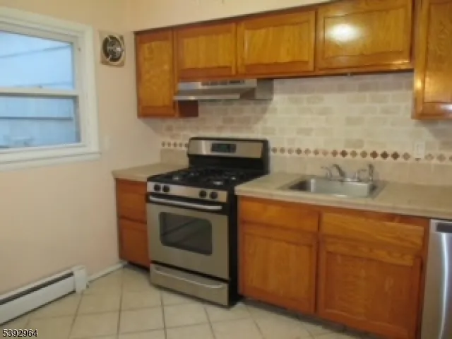 a kitchen with granite countertop a stove and a sink