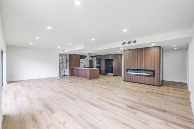 a view of kitchen with wooden floor and electronic appliances