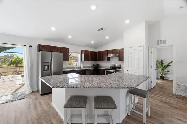 a dining room with furniture and wooden floor