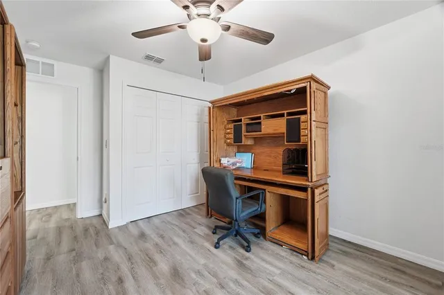 a view of workspace with wooden floor and windows