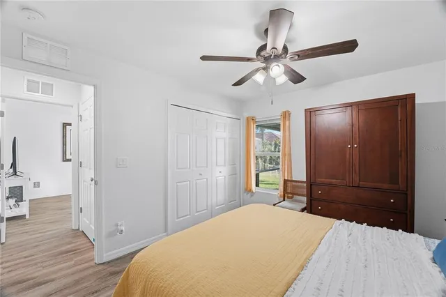 a bathroom with a granite countertop sink a toilet a shower and a mirror