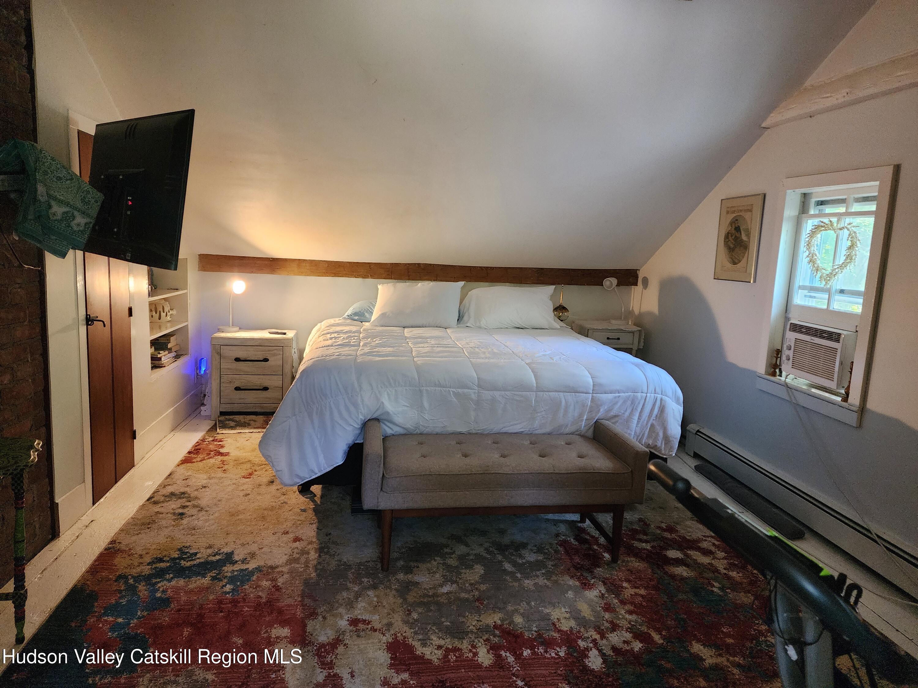 9 Hamm Road Durham, NY 12422 - Photo 12 of 21 a bed sitting in a bedroom next to a window