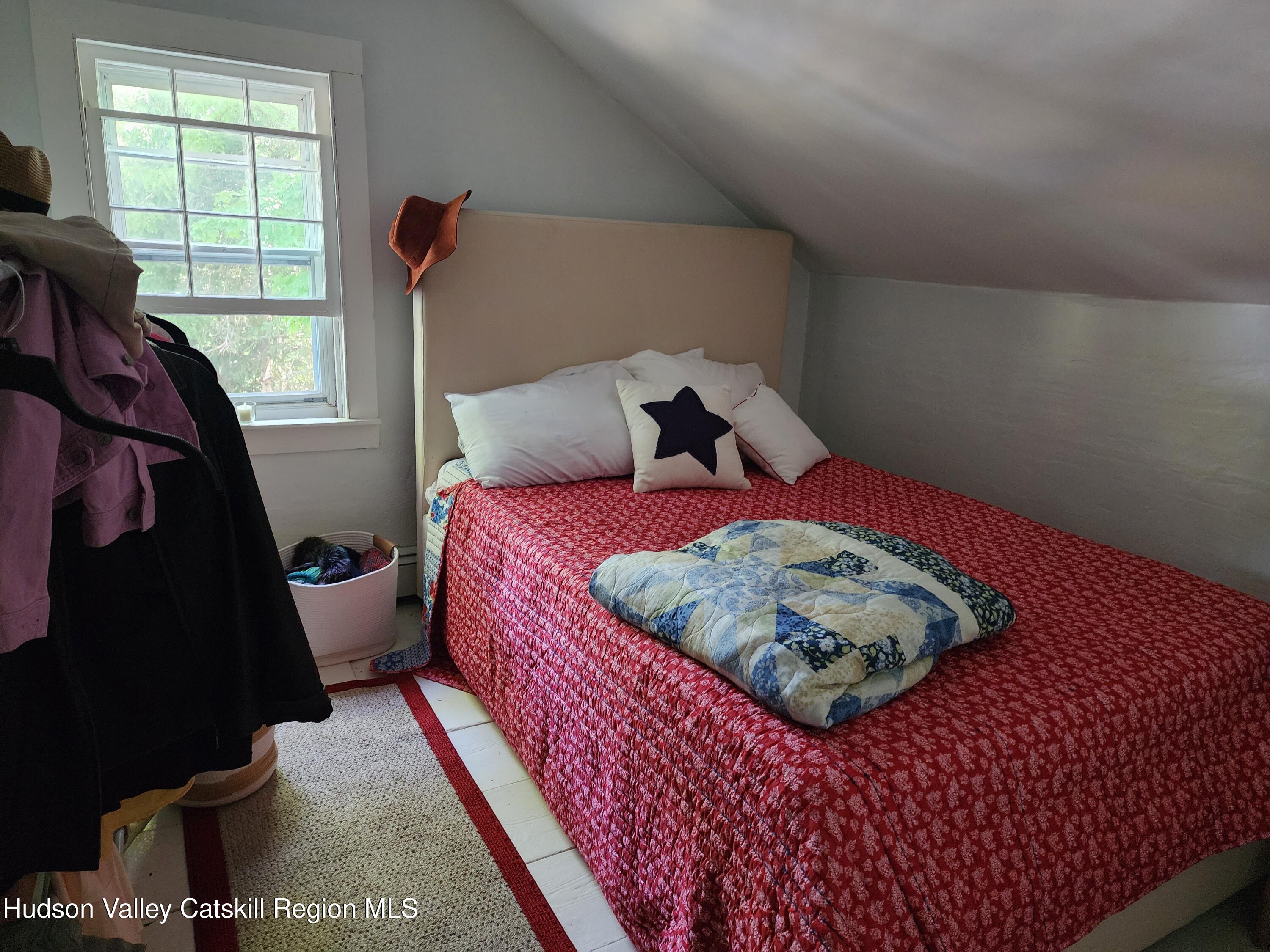 9 Hamm Road Durham, NY 12422 - Photo 13 of 21 a bed sitting in a bedroom next to a window