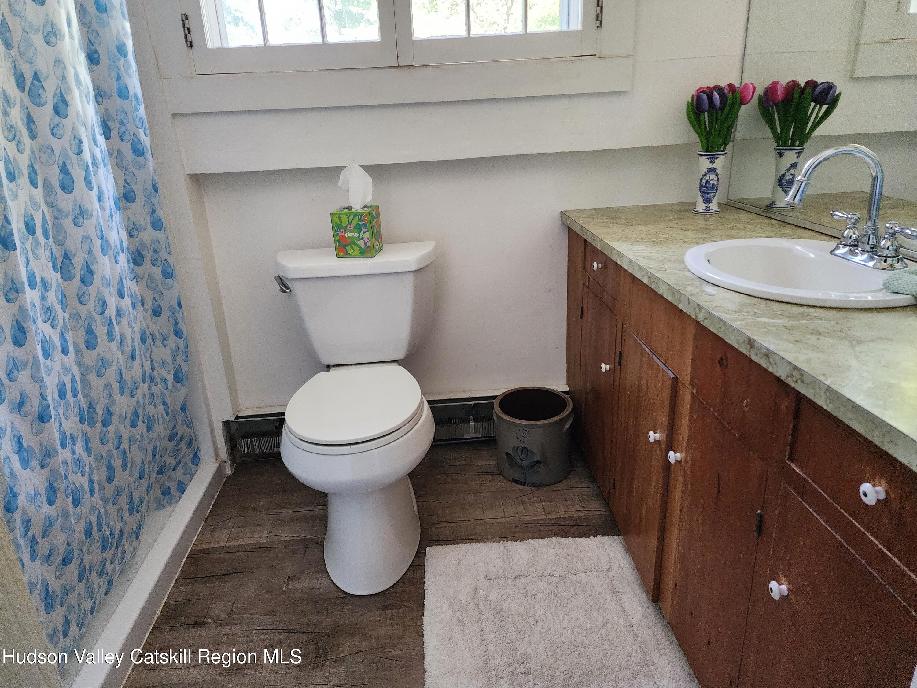 9 Hamm Road Durham, NY 12422 - Photo 10 of 21 a bathroom with a granite countertop toilet sink and mirror