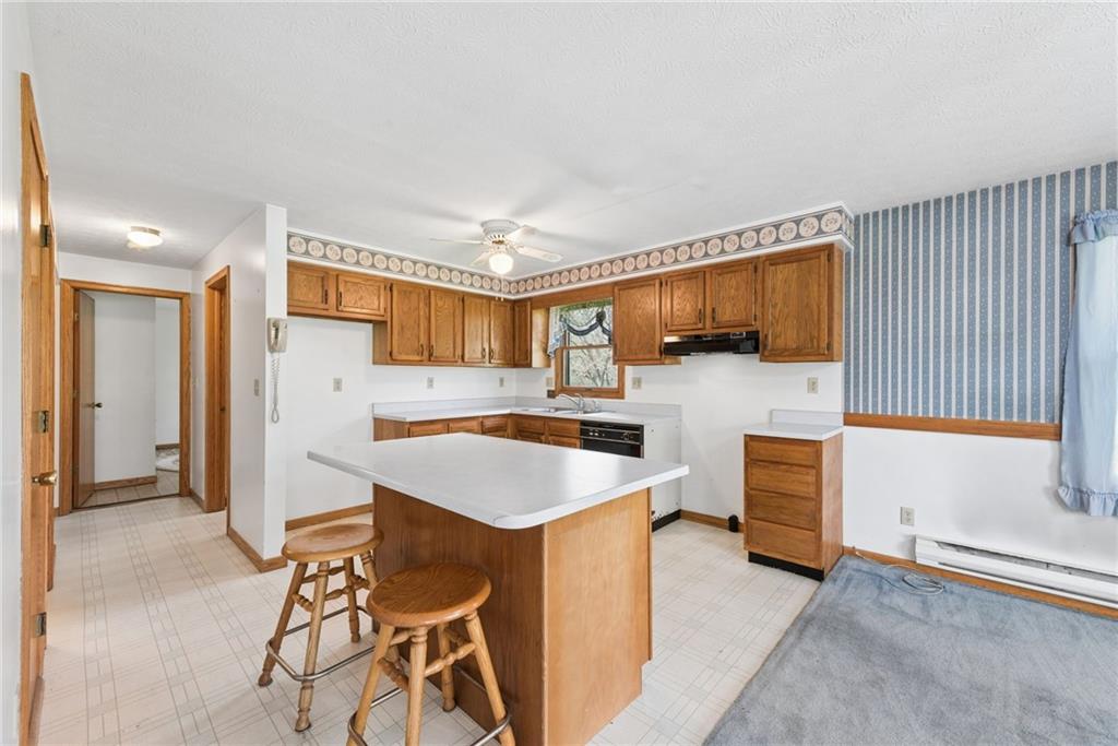 136 Bottom Road Mill Run, PA 15464 - Photo 13 of 26 a kitchen that has a sink and a stove in it