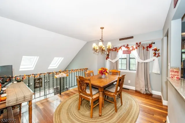 a view of a dining room with furniture and chandelier