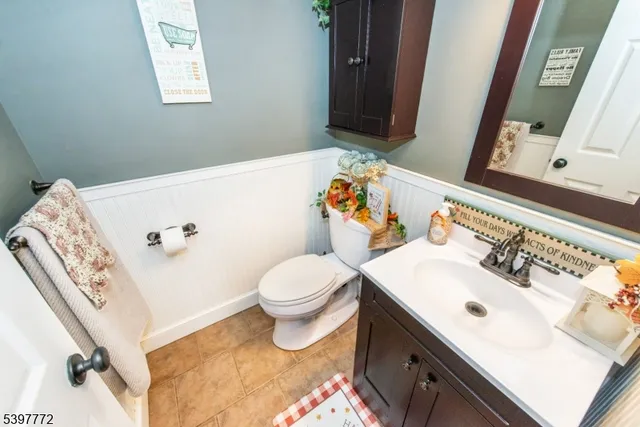 a bathroom with a sink vanity mirror and toilet