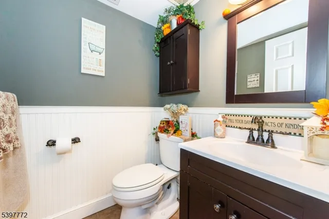 a bathroom with a sink toilet and mirror
