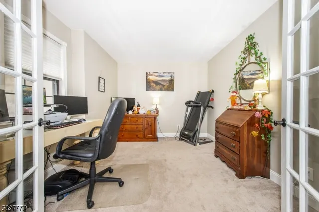 a view of a workspace with furniture and a window