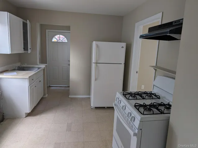 a kitchen with a stove and a refrigerator