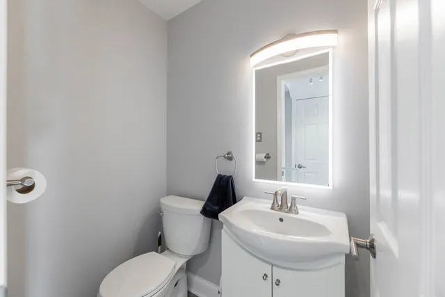 a bathroom with a sink a toilet and mirror