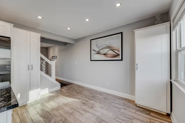a view of hallway with wooden floor and staircase