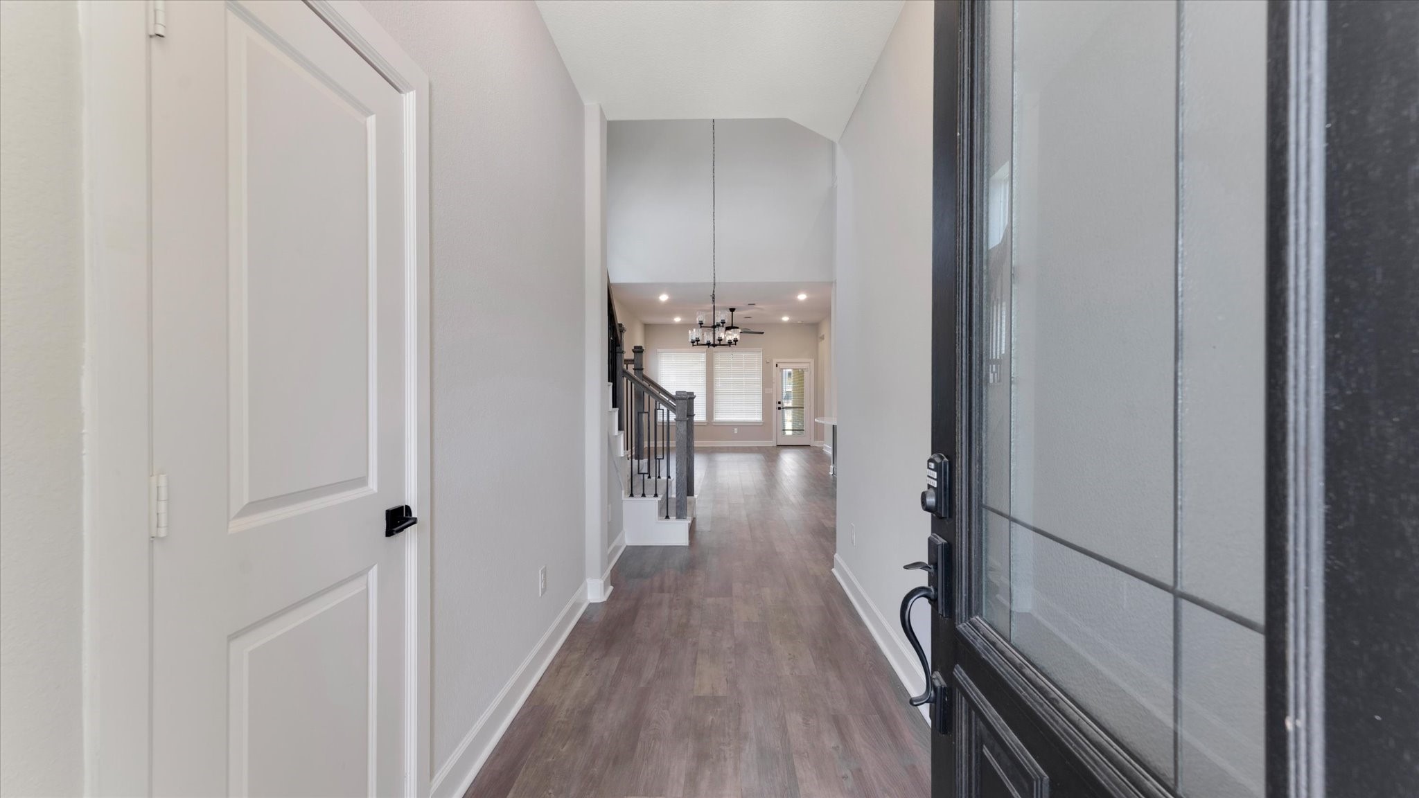 15607 Rising Wren Court Conroe, TX 77302 - Photo 5 of 40 a view of a hallway with wooden floor and staircase