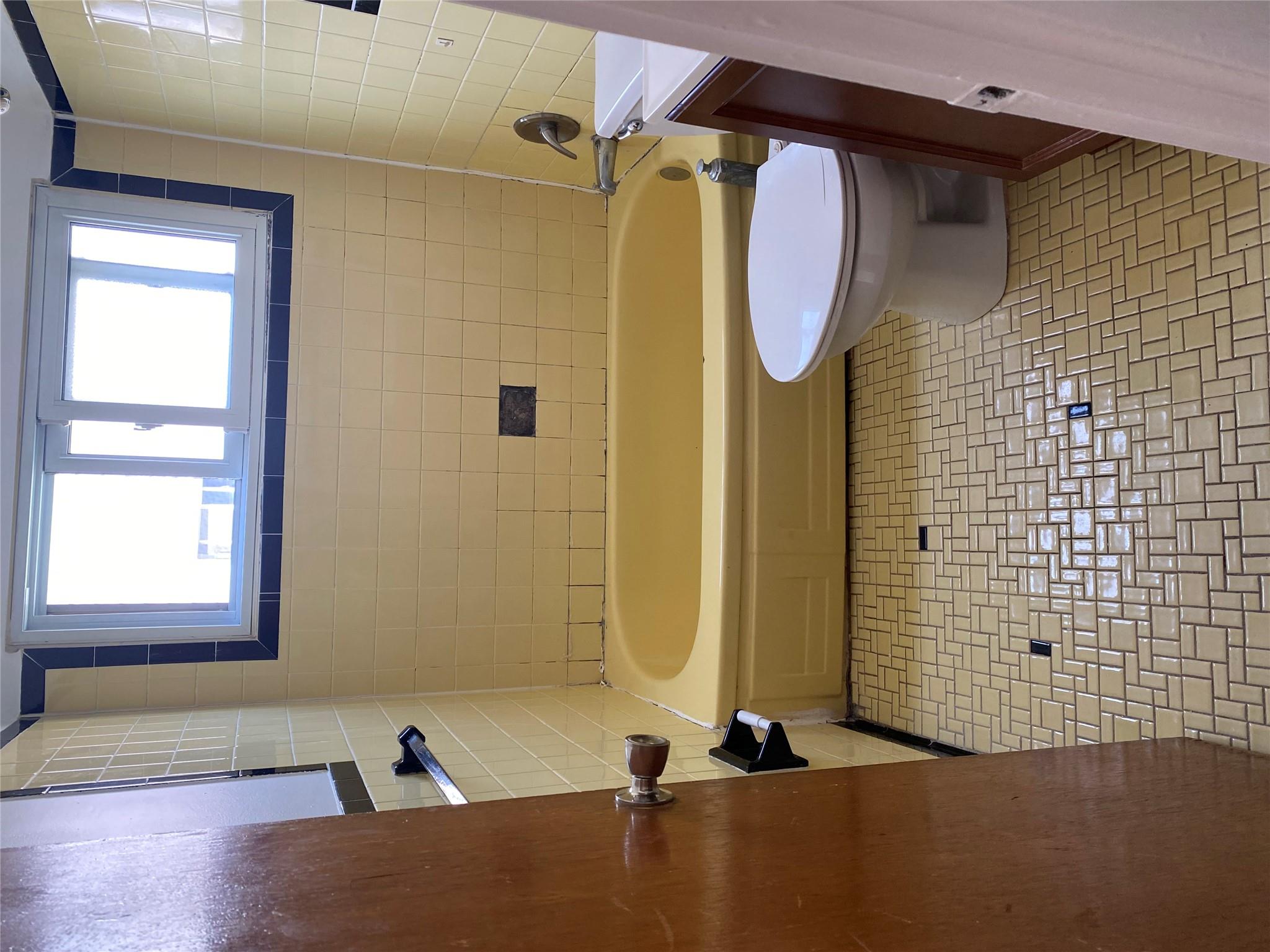 129-32 145th Street Queens, NY 11436 - Photo 12 of 15 a bathroom with a toilet a sink and a bathtub