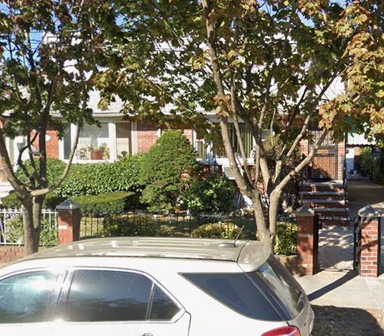 129-32 145th Street Queens, NY 11436 - Photo 14 of 15 a view of a white house with a large tree