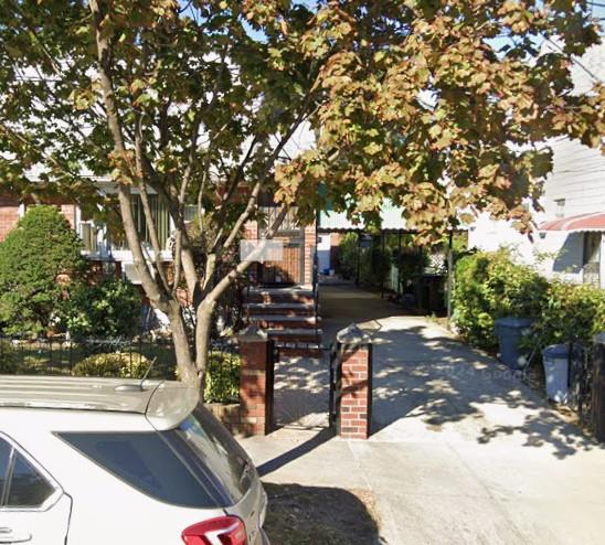 129-32 145th Street Queens, NY 11436 - Photo 3 of 15 a view of backyard with outdoor seating and trees