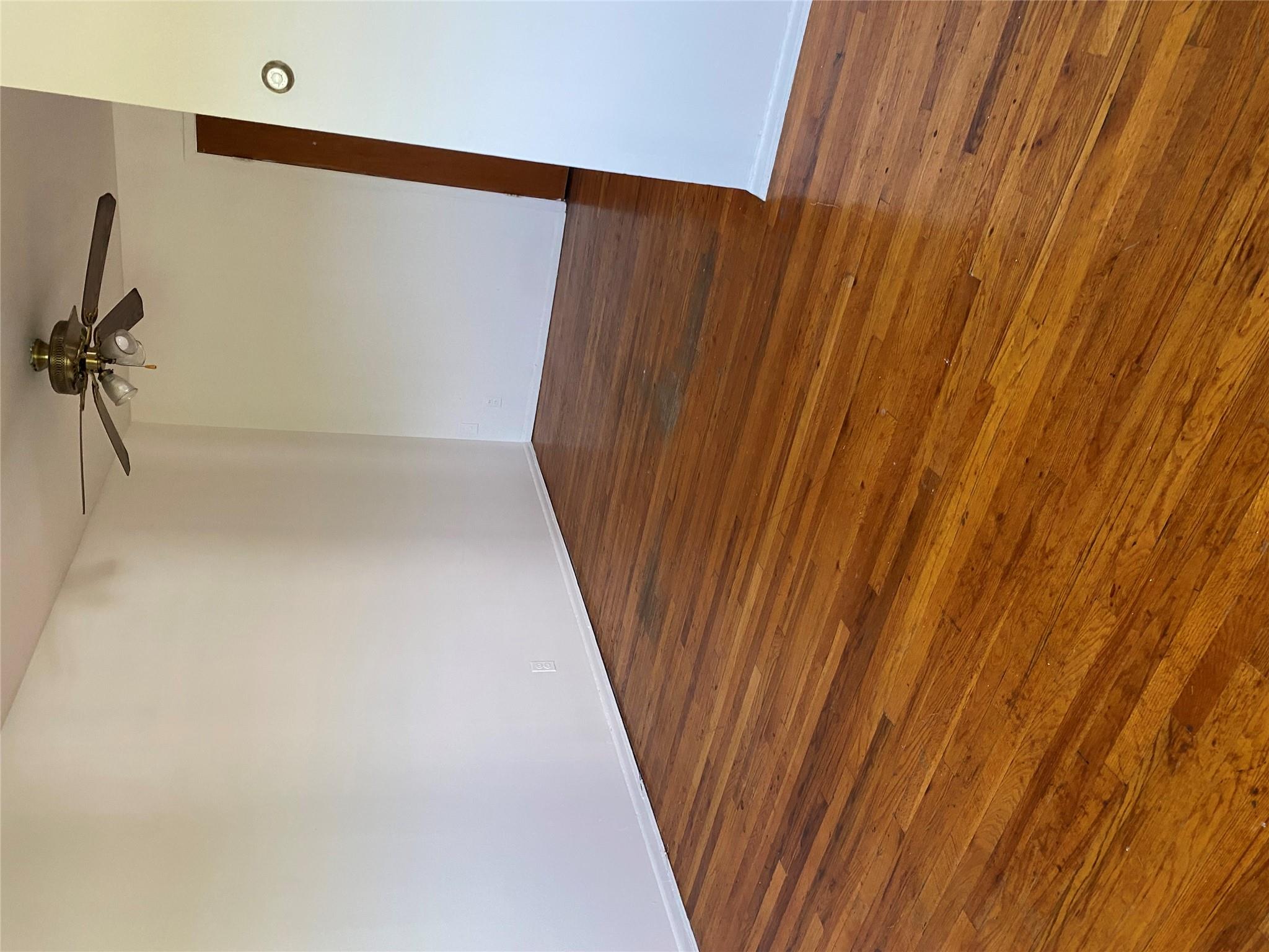 129-32 145th Street Queens, NY 11436 - Photo 5 of 15 wooden floor in a empty room