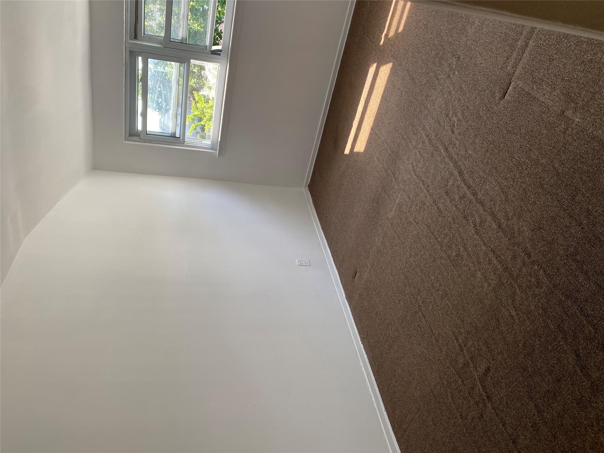 129-32 145th Street Queens, NY 11436 - Photo 10 of 15 an empty room with windows