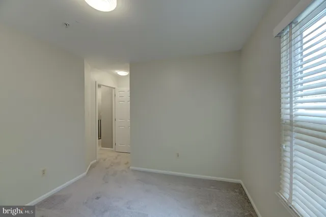 a view of an empty room and a window