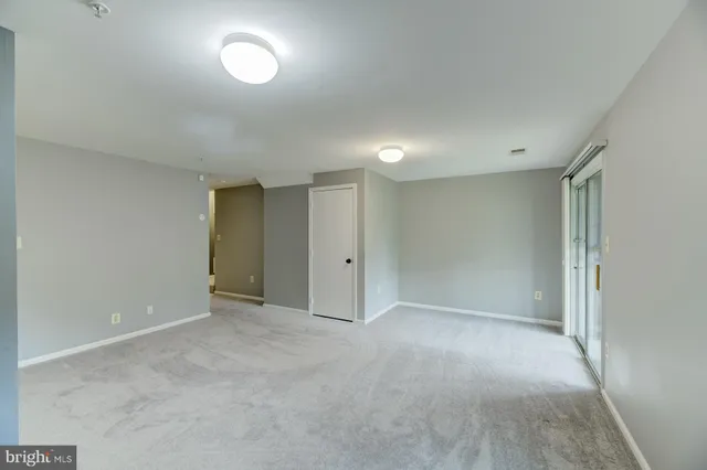 a view of an empty room and a window