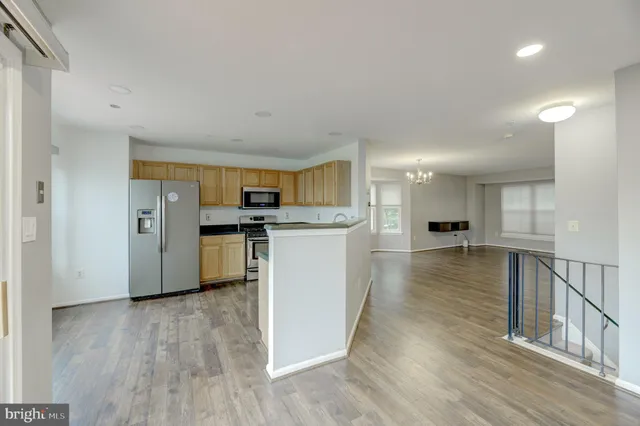 a view of kitchen with cabinets and wooden floor