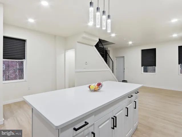 a view of a kitchen with a table and chairs