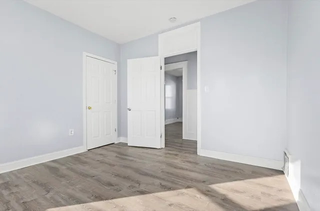 an empty room with wooden floor