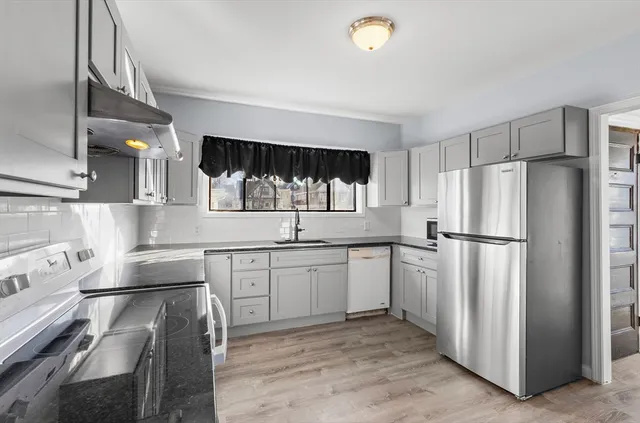 a kitchen with a sink appliances and cabinets