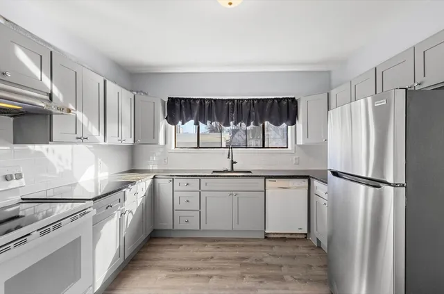 a kitchen with a sink appliances and cabinets