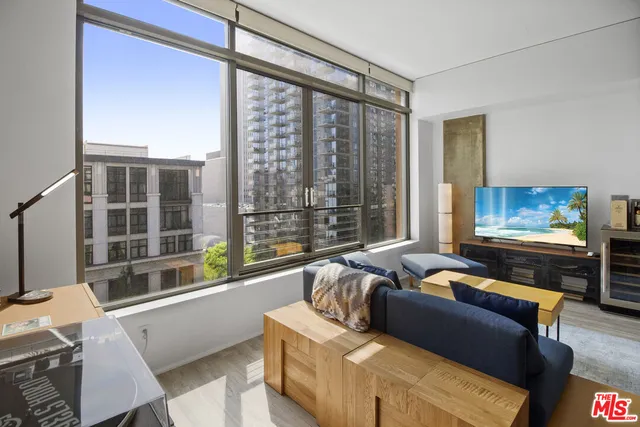 a living room with furniture and a floor to ceiling window