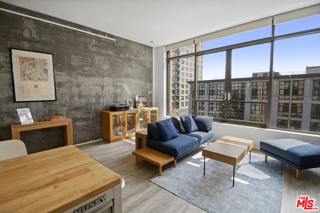 a living room with furniture and a floor to ceiling window