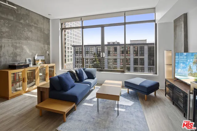 a kitchen with granite countertop a sink a counter space and stainless steel appliances