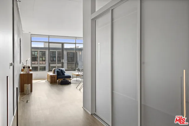 a kitchen with granite countertop a refrigerator and stainless steel appliances