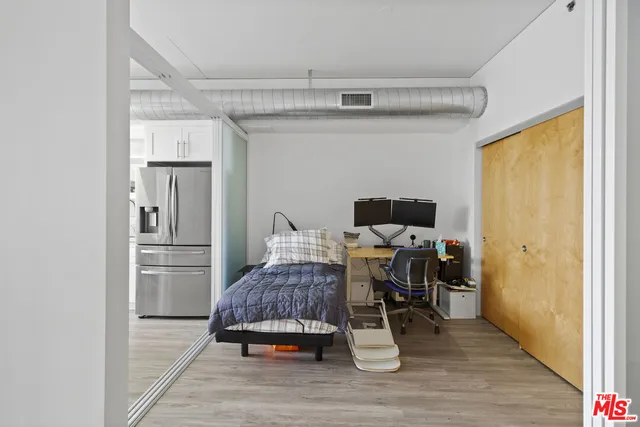 a bedroom with a bed chair and a window