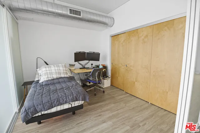 a bathroom with a granite countertop sink a toilet and a mirror