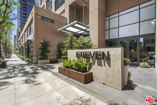 a view of a building and car parked on the side of road