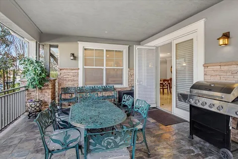 a view of a patio with a table chairs and a backyard