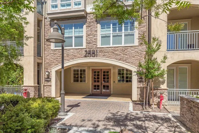 a front view of a house with a garden