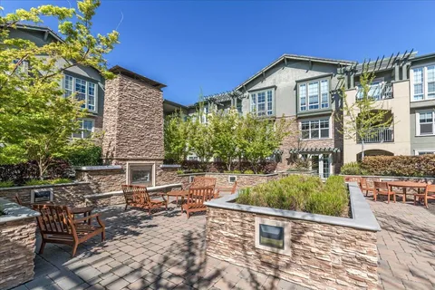 a view of a house with pool and sitting area