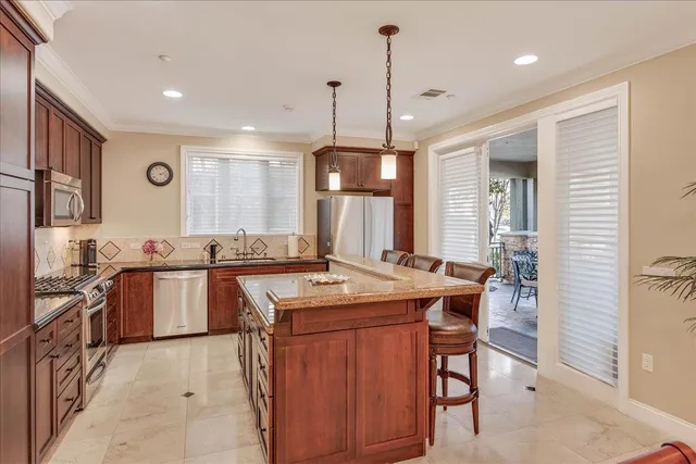 a view of a dining room with furniture a chandelier and wooden floor