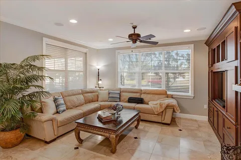 a living room with furniture a flat screen tv and a fireplace