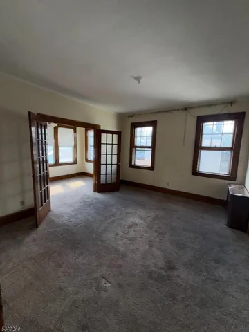 an empty room with windows and closet